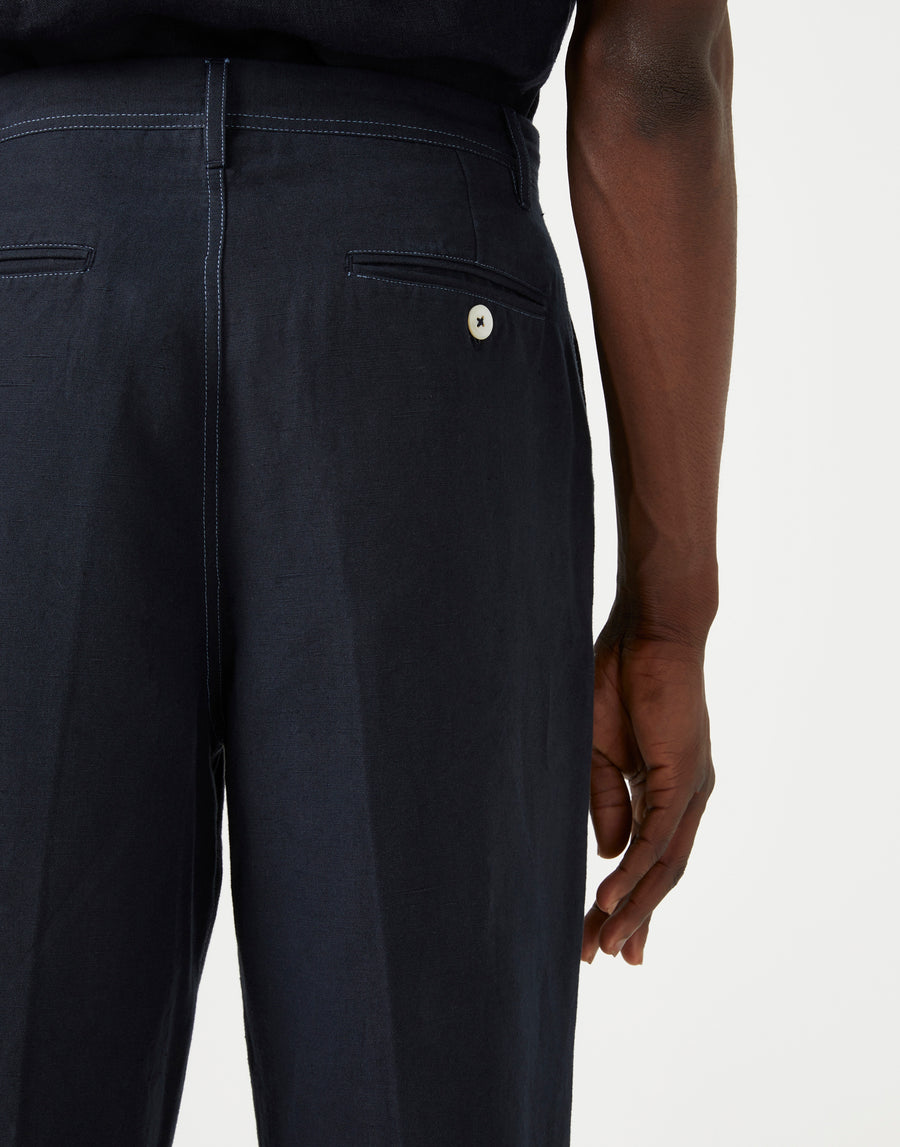 Close up of white stitching detail on men's dark navy casual trousers